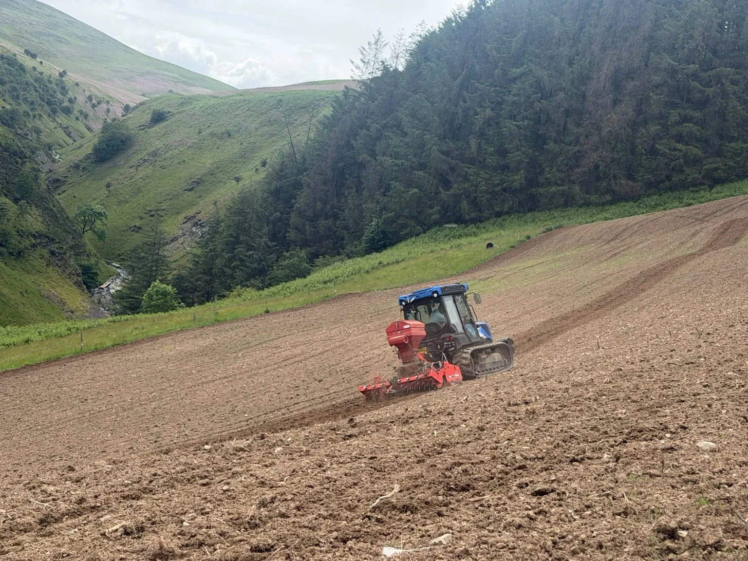 Tracked tractor working on a steep hillside